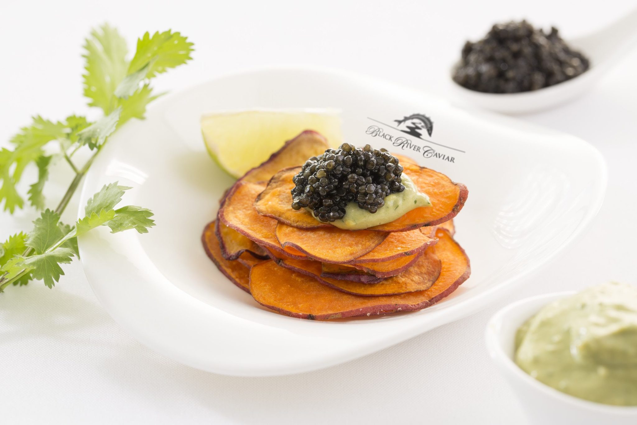 Sweet potato chips with guacamole and caviar Black River Caviar