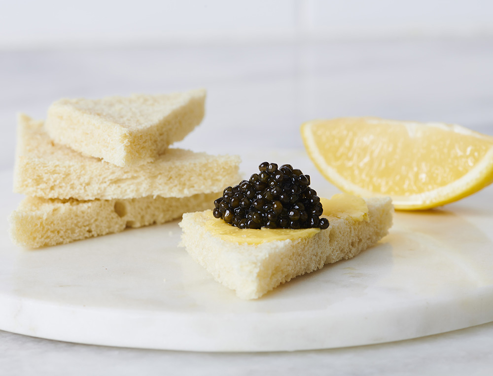 Toast with unsalted butter and little lemon, topped with Black River Caviar.